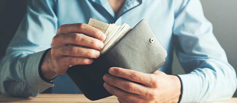 businessman hand wallet with money
