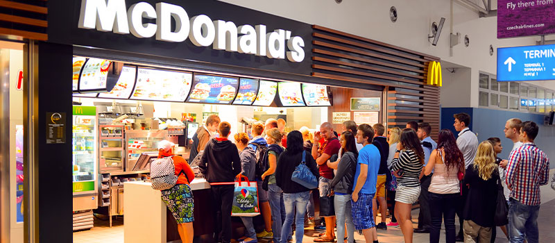 People fall in line to buy food at McDonalds