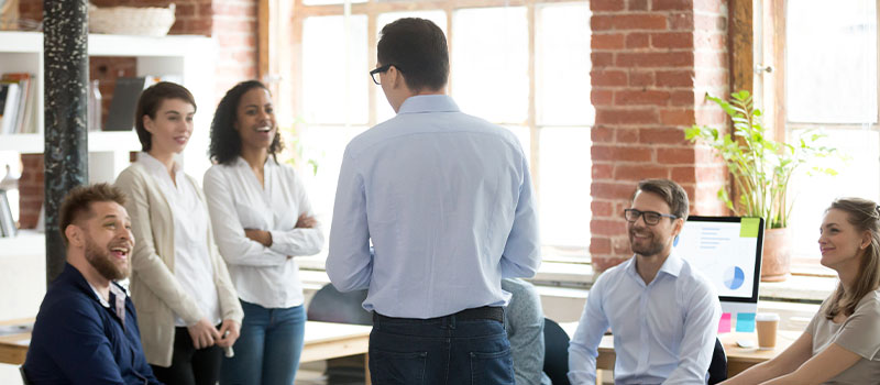 Company boss executive manager talking with company members during briefing at coworking modern comfortable office.