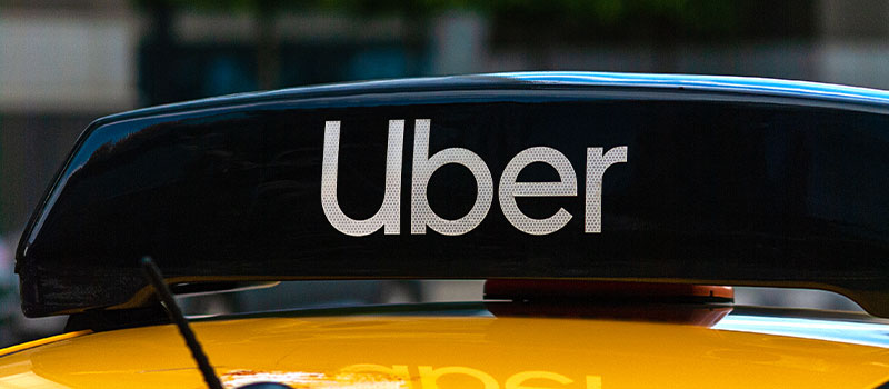 uber logo above taxi sign